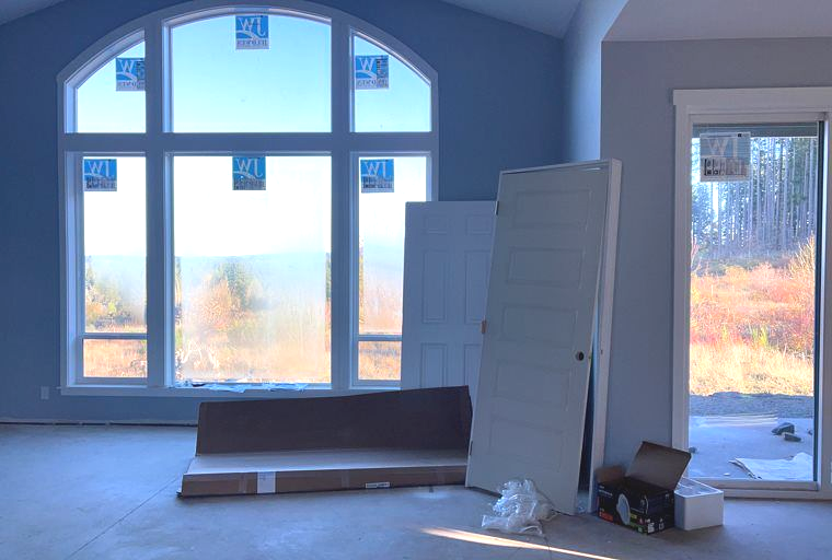 An empty room with a lot of windows and doors