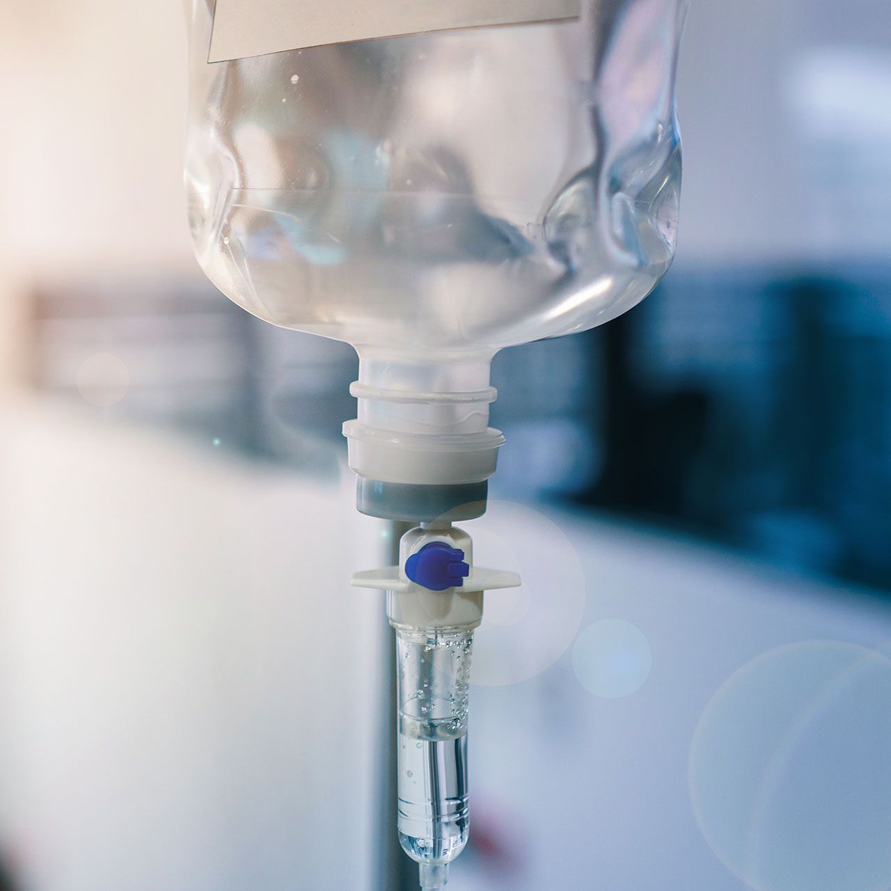 Healthcare concept, Close up of medical drip or IV drip chamber in patient room, Selective focus.