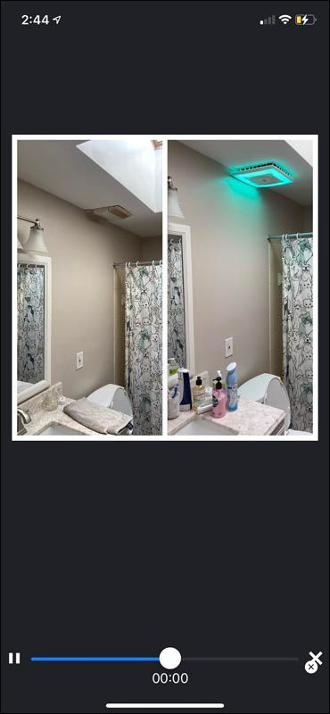 Side-by-side bathroom mirror photos showing ceiling light change from warm white to teal