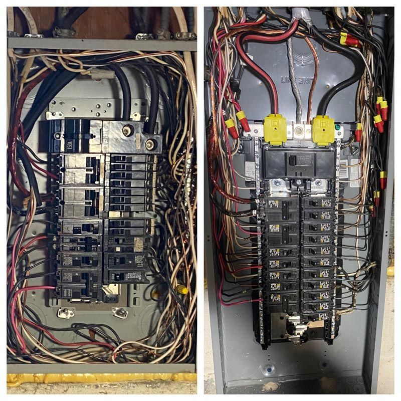 Two electrical breaker panels side by side with exposed wiring in a utility space