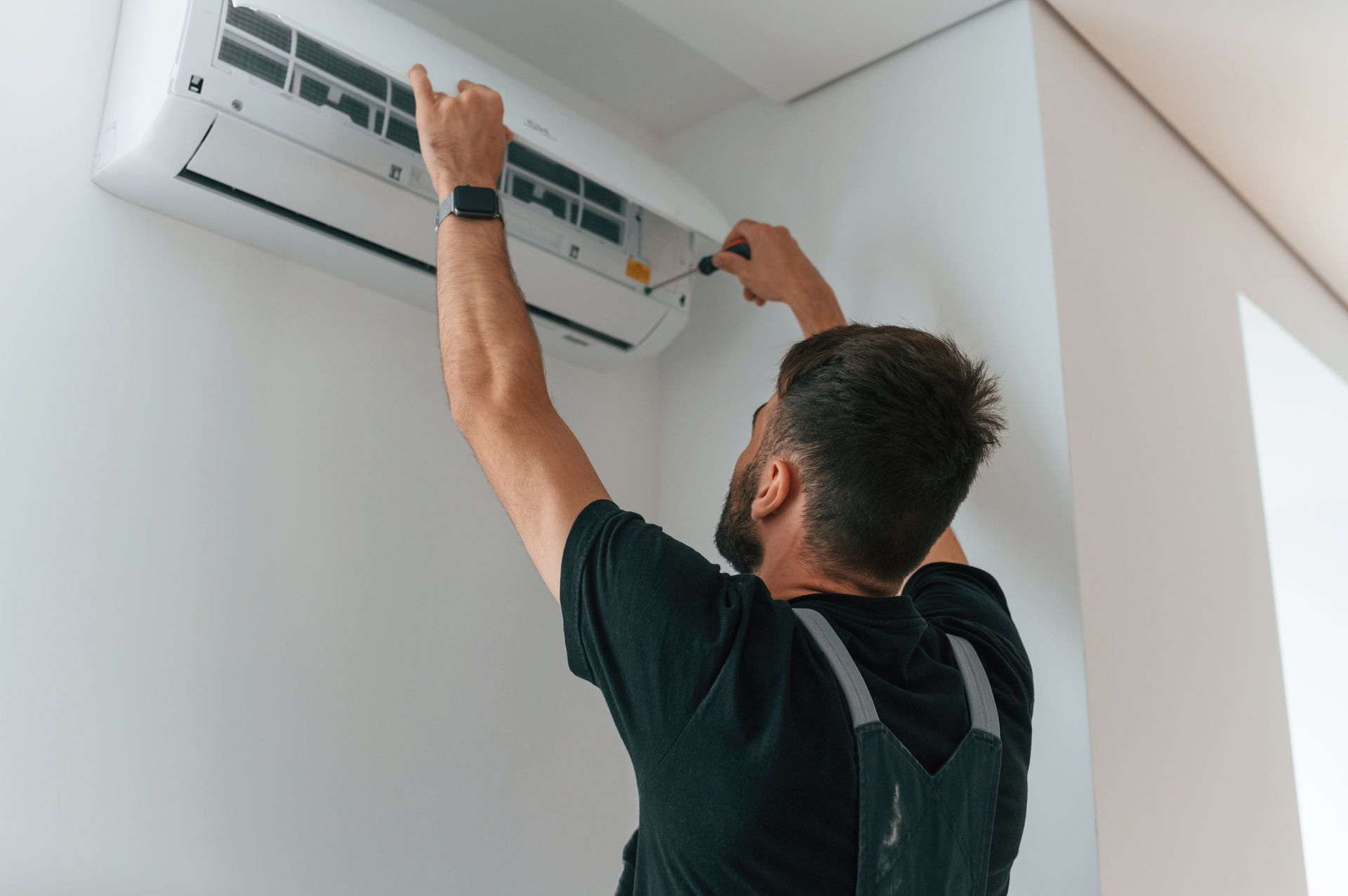 HVAC contractor working on residential AC unit 