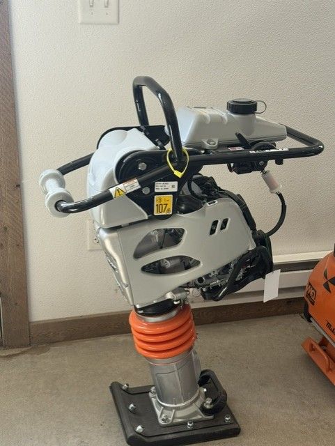 Yellow trench-digging machine on a dirt construction site