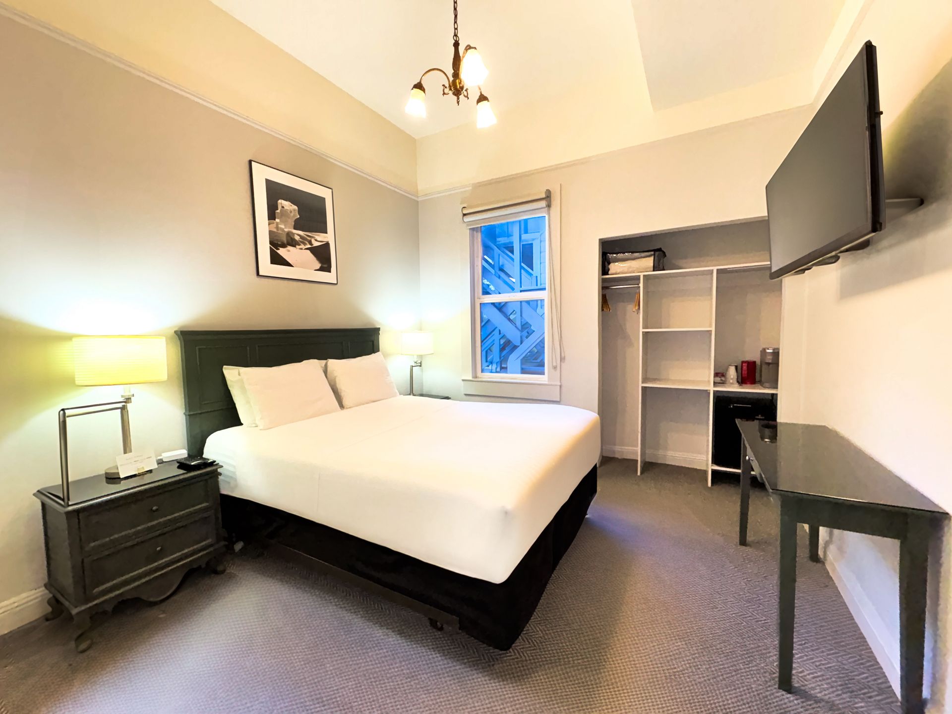 A hotel room with a large bed and a flat screen tv