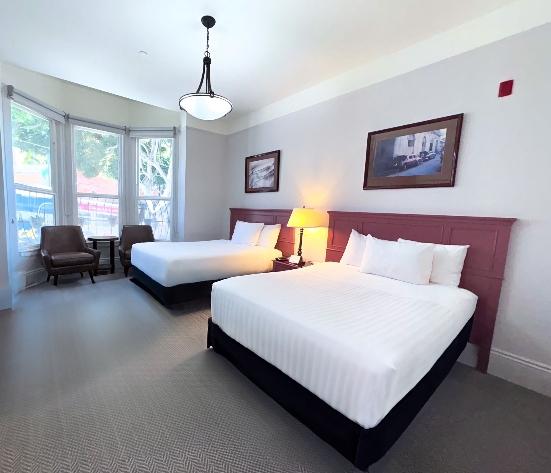 A hotel room with two beds and a chair