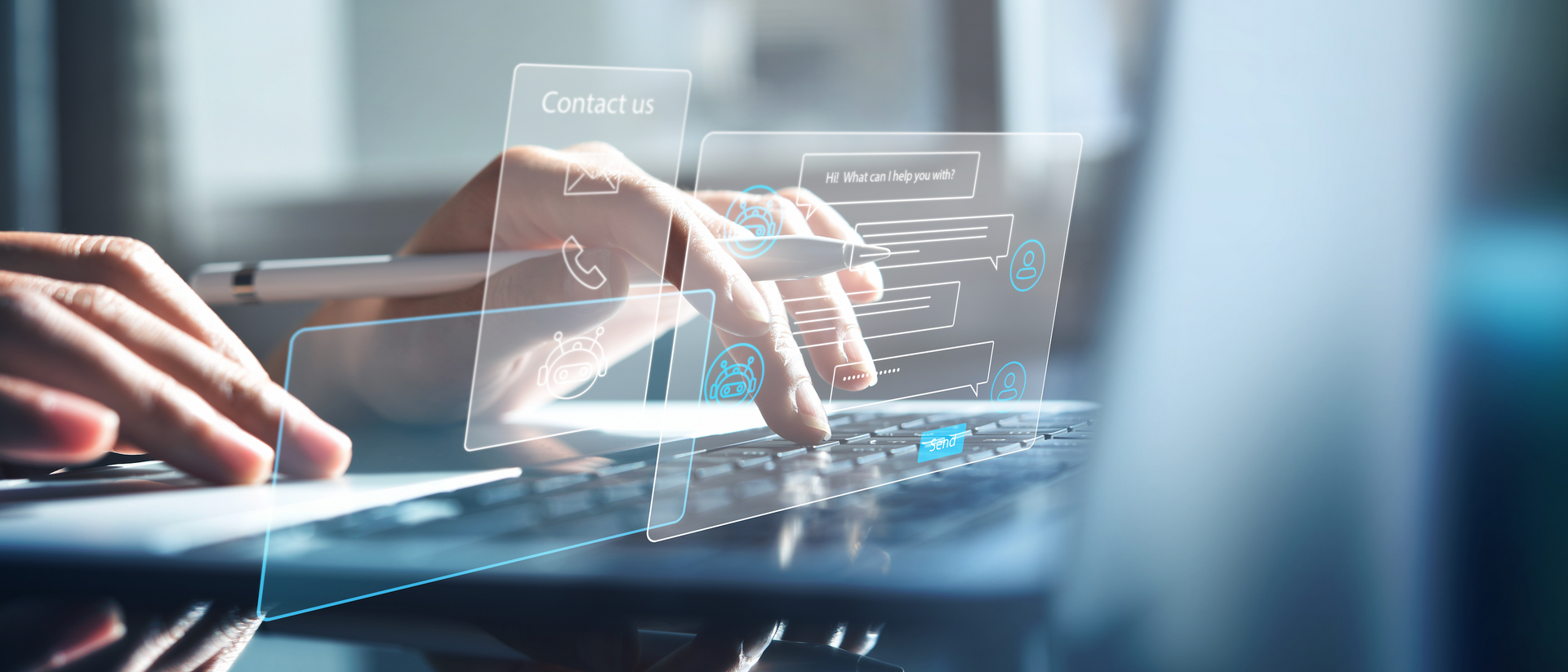 Hands typing on a laptop keyboard with futuristic holographic user interface overlay. Blue lighting and blurred background.