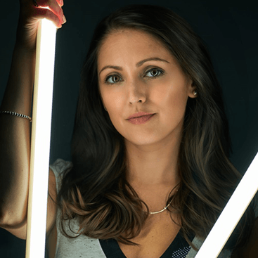 A woman is holding a light in her hand
