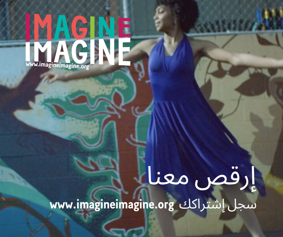A woman in a blue dress is dancing in front of a wall that says imagine imagine