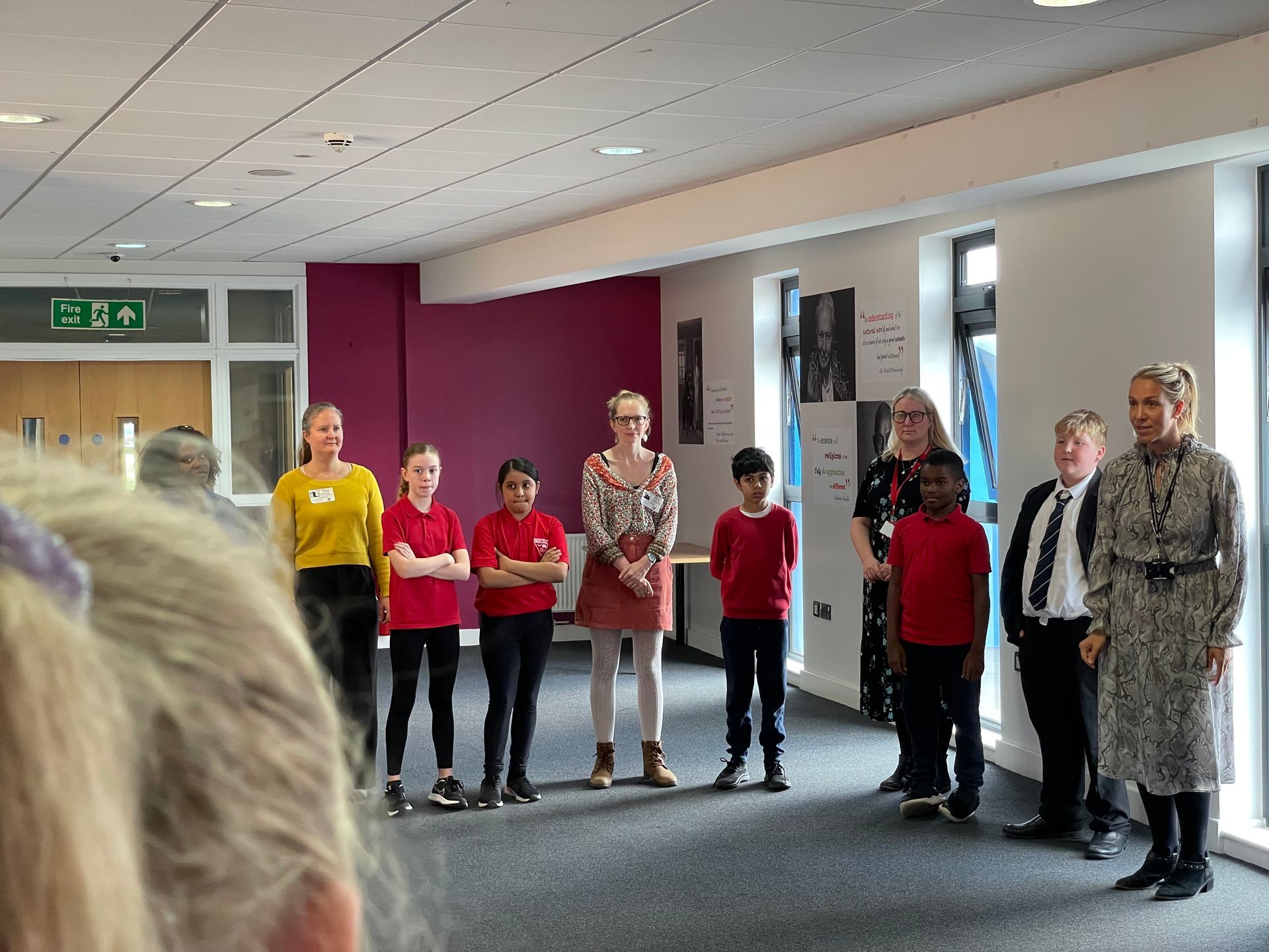 A group of people are standing in a room.
