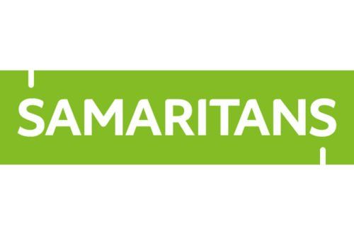 A green sign with the word samaritans on it.