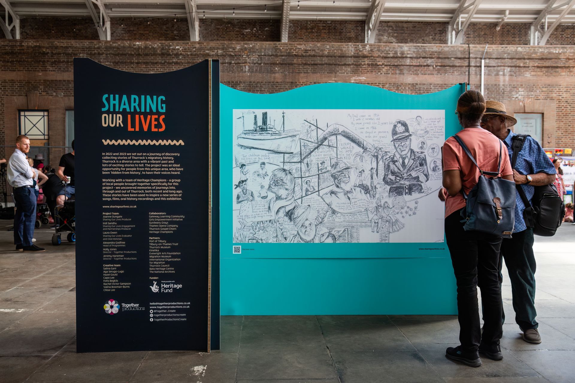 A group of people are standing in front of a sign that says sharing our lives.