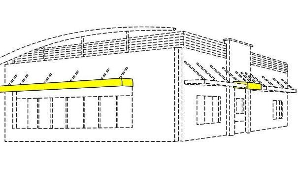 Building exterior with a yellow awning extending from the side.