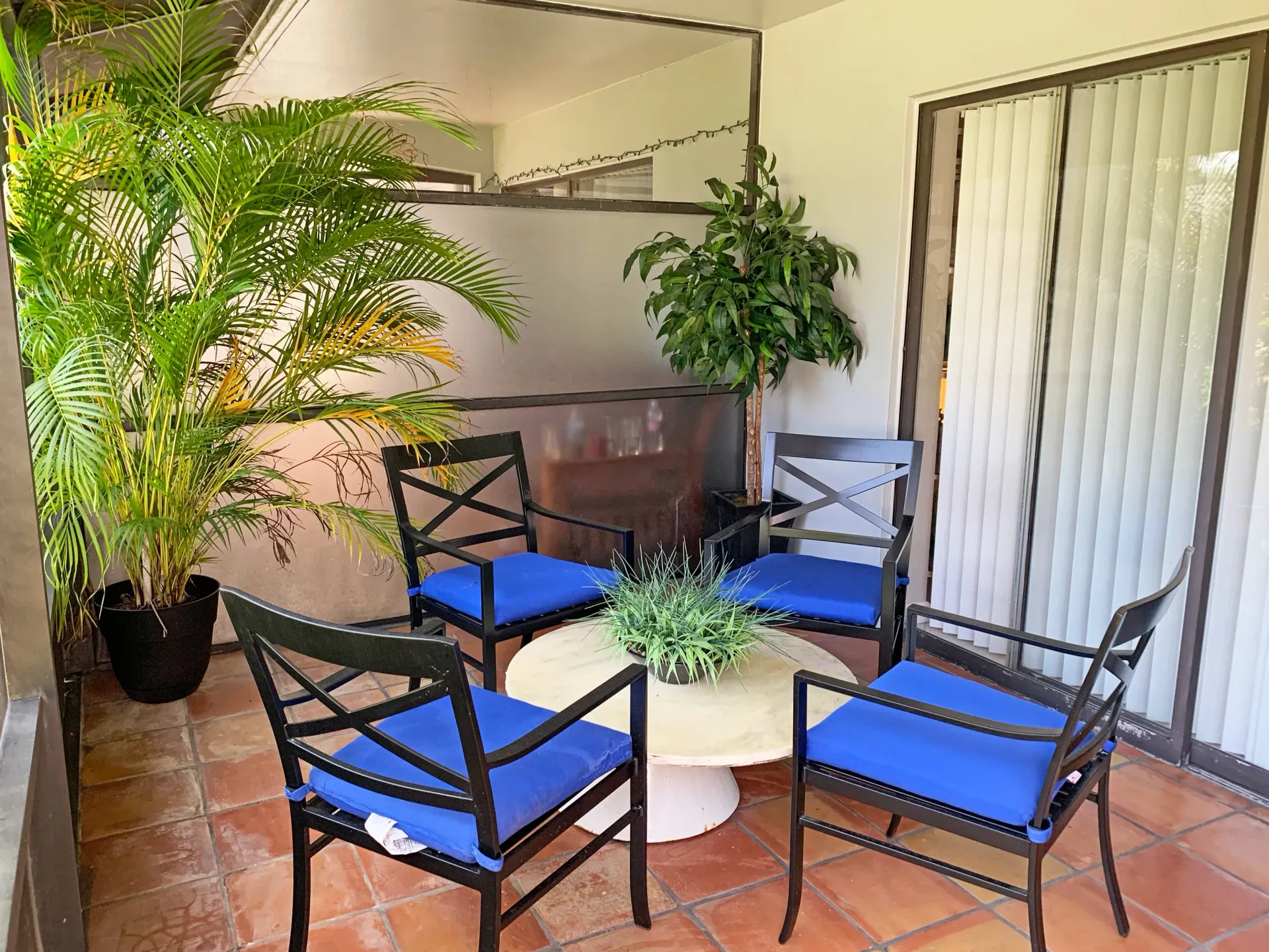 Cozy outdoor seating area with potted plants at Turnbury at Palm Beach Gardens, offering pet-friendly apartments in Palm Beach Gardens, FL.