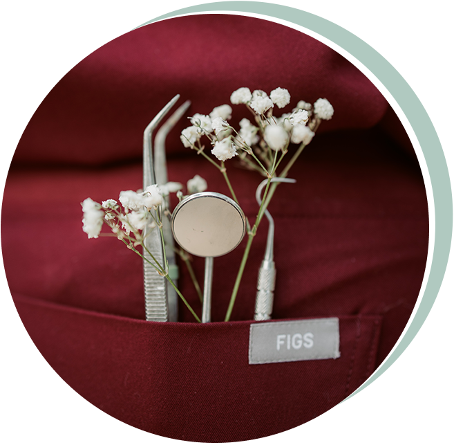 Dental tools and white flowers in a red pocket, with a