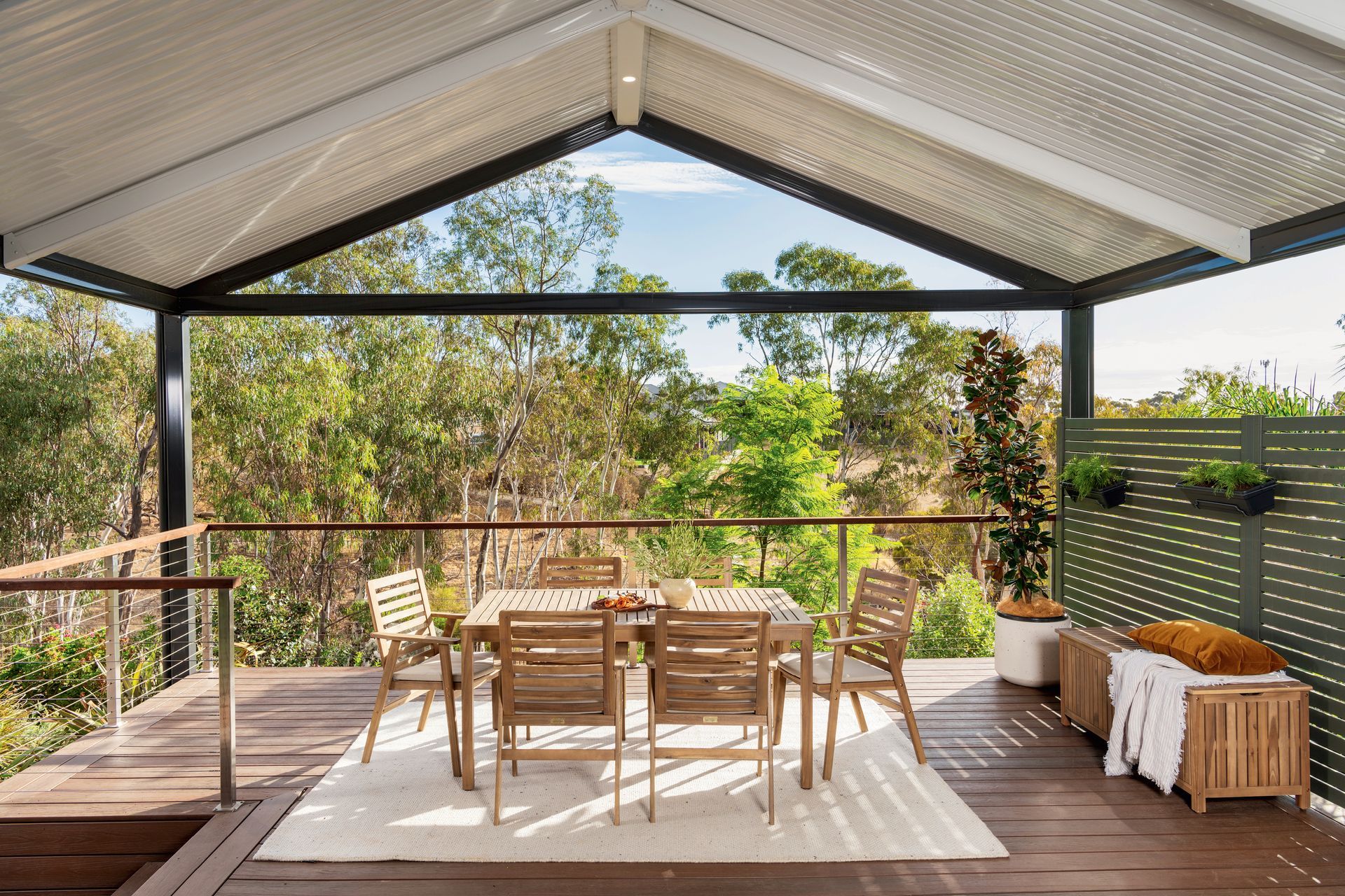 Patio with People Seated at A Table Under a White Canopy — Precision Patios Toowoomba In Toowoomba, QLD