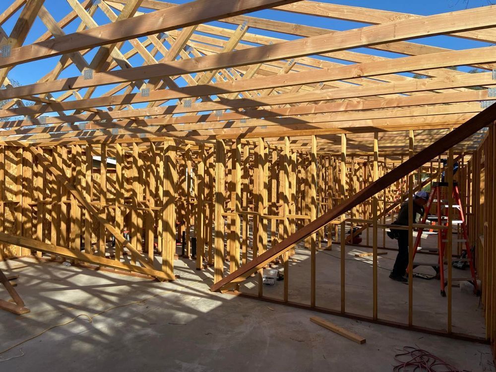 A man is standing in the middle of a building under construction.
