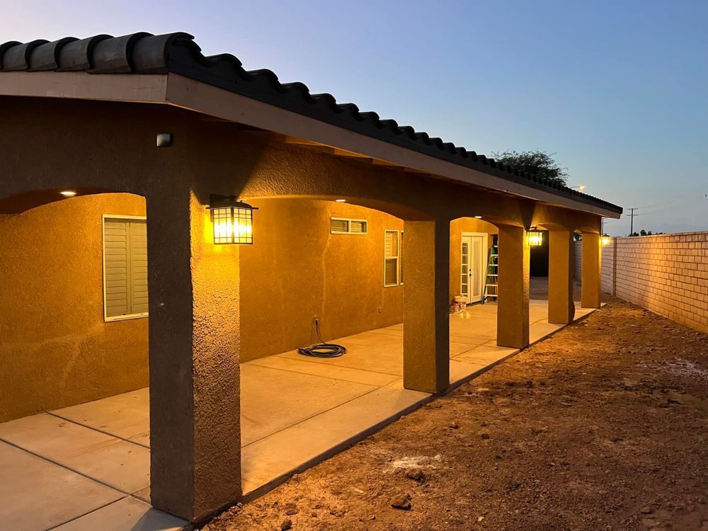 A house with a covered porch that is lit up at night