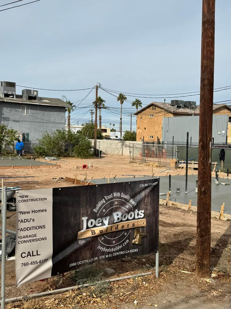 A construction site with a sign that says joey boots on it
