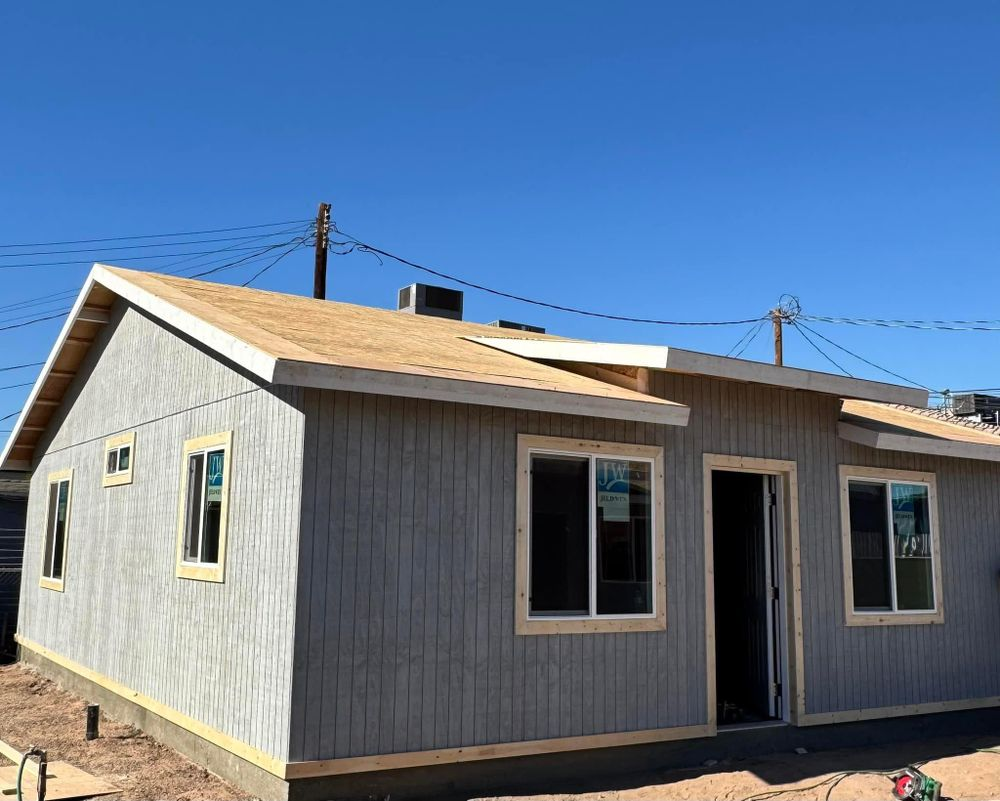 A small house with a roof that is being built