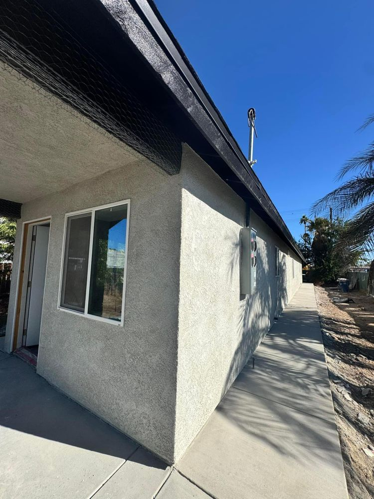 A house with a lot of windows and a walkway leading to it