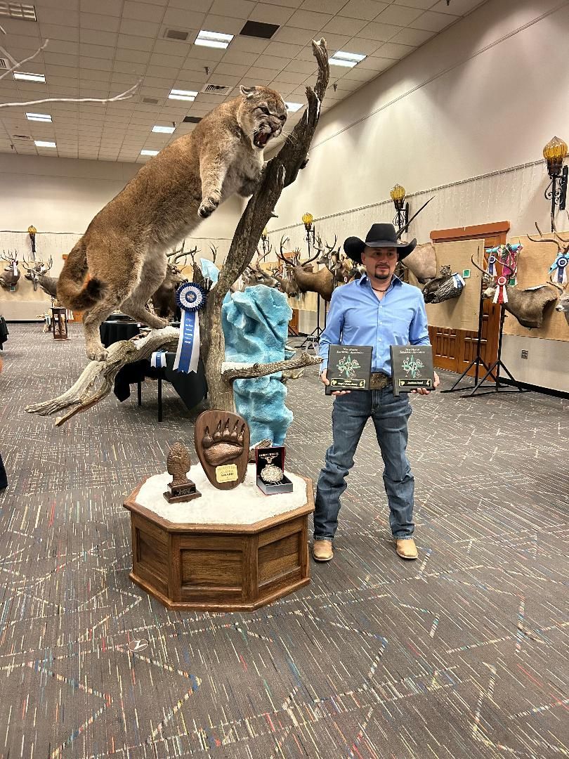 A man is standing in front of a stuffed animal in a room.