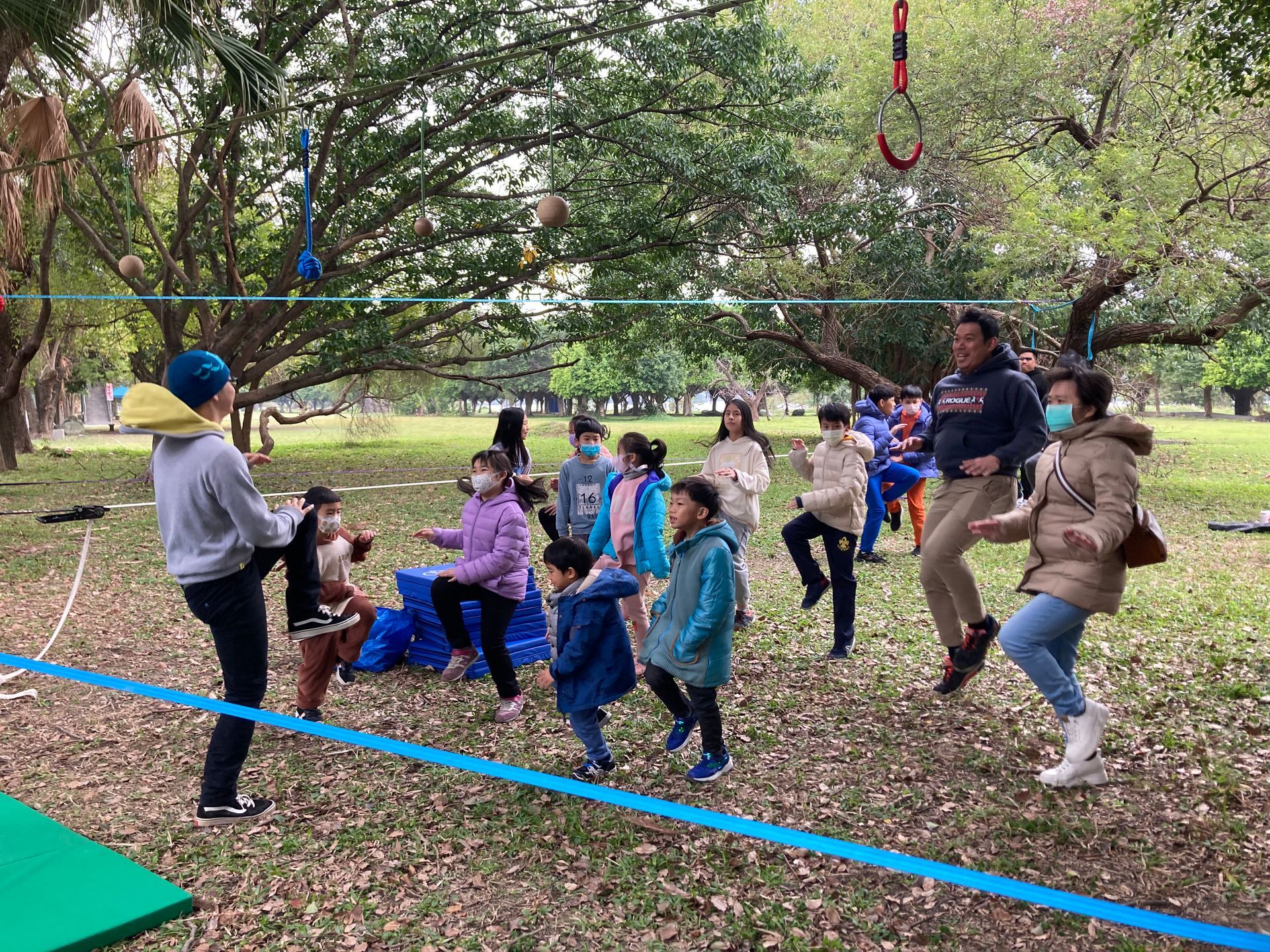 A group of people are playing a game in a park.