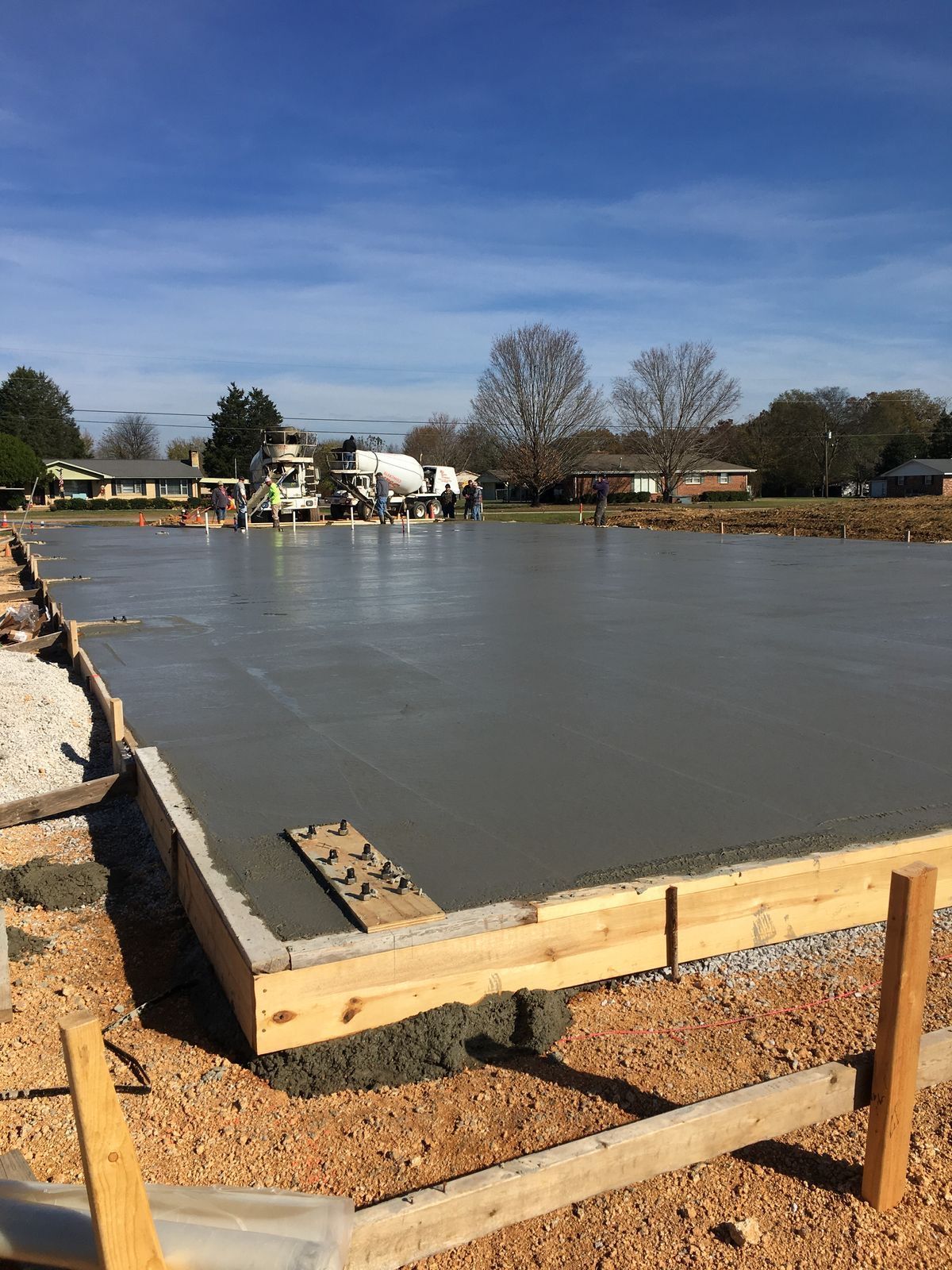 Repairing a concrete wall with a trowel and cement, showing rebar reinforcement.