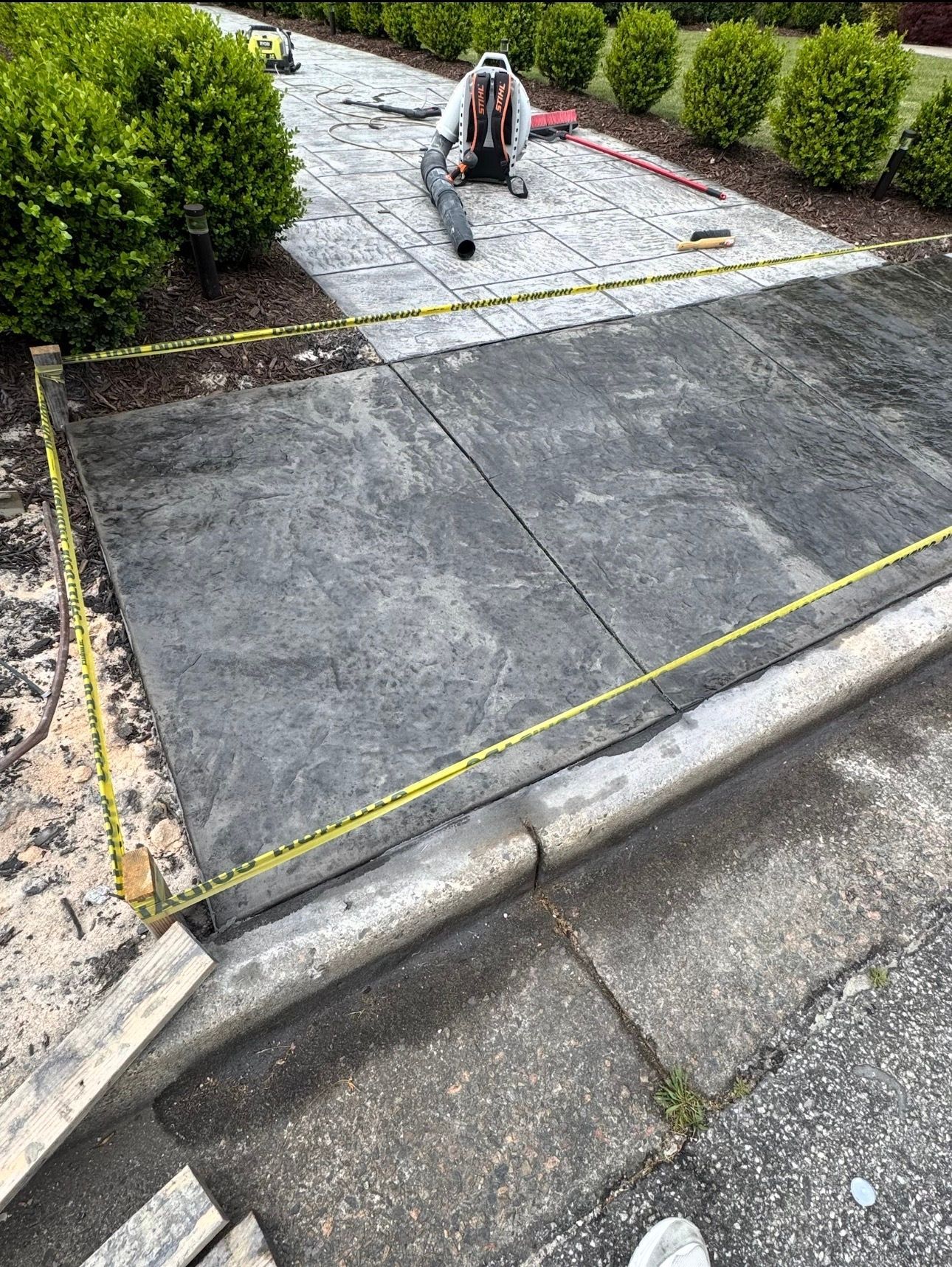 Repairing a concrete wall with a trowel and cement, showing rebar reinforcement.