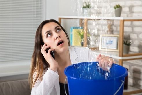A Woman Is Talking on A Cell Phone — Origin Plumbing & Gas in Tuckurimba, NSW