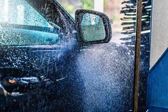 A car is being washed in a car wash.