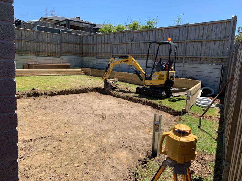 Excavator Tearing Up Backyard For Renovation — JohnCorp Property Maintenance In Emerald, QLD