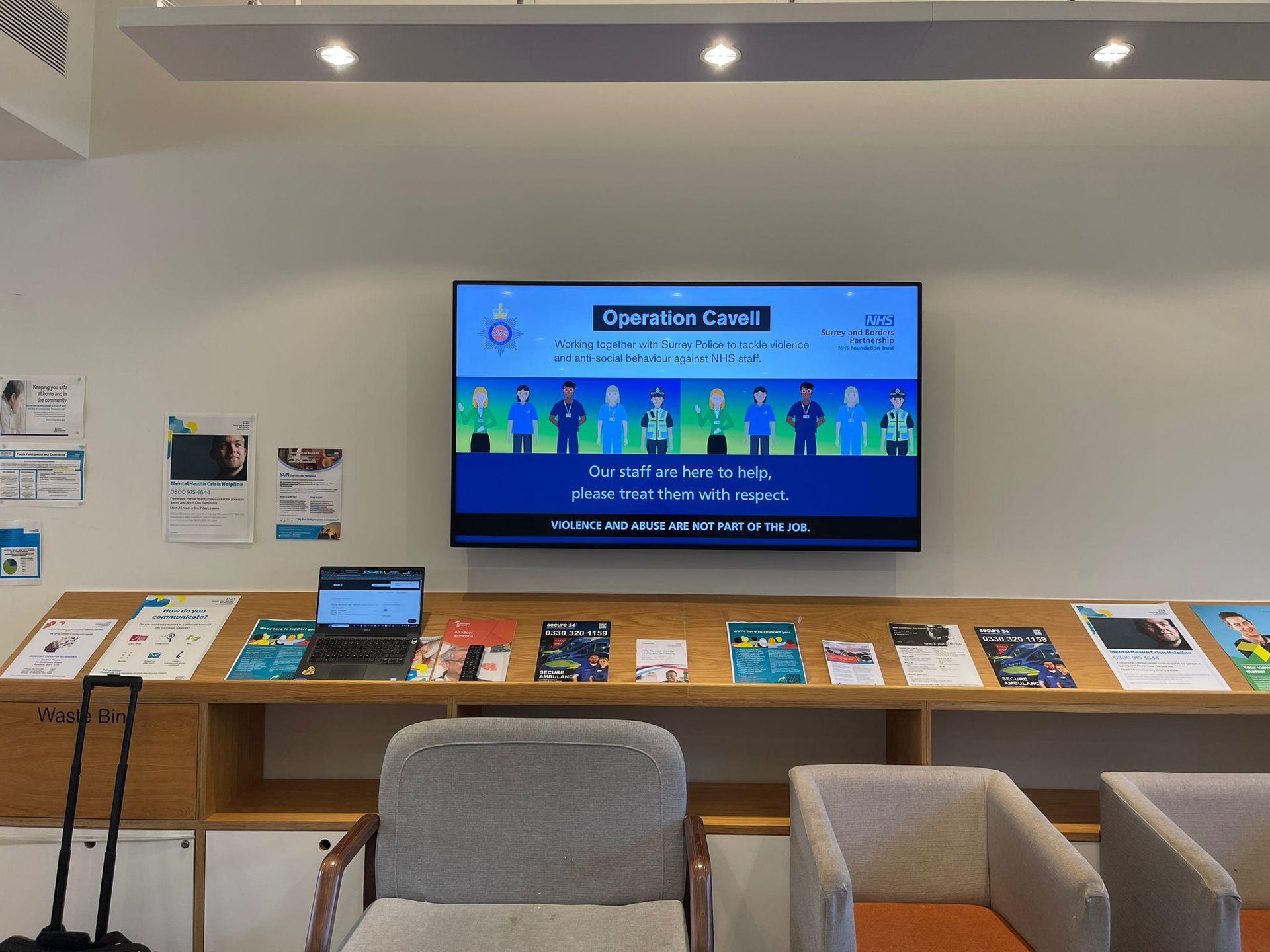 Shared workplace area with a wall-mounted digital signage display