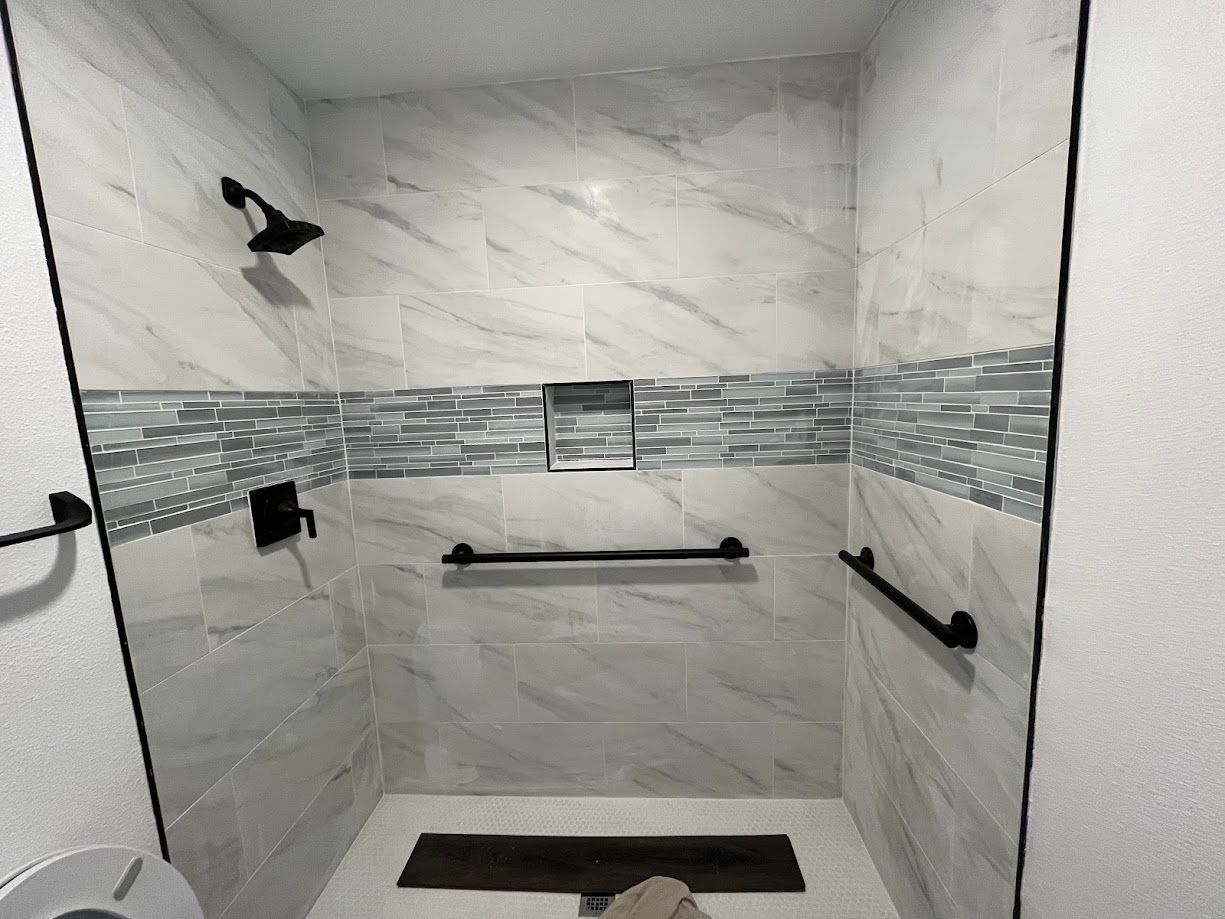 A bathroom with a walk in shower and a toilet.