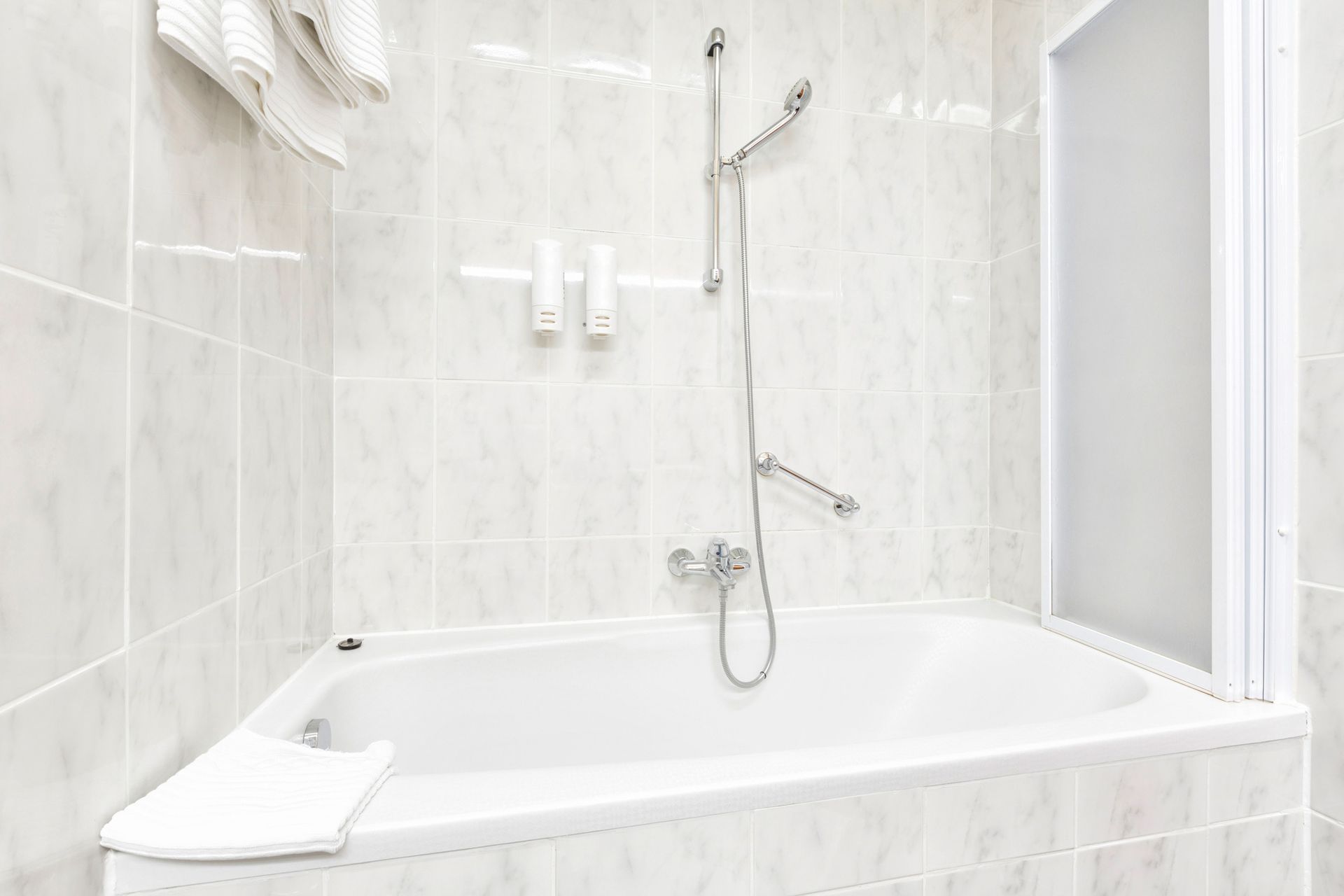 A bathroom with a bathtub and a shower.