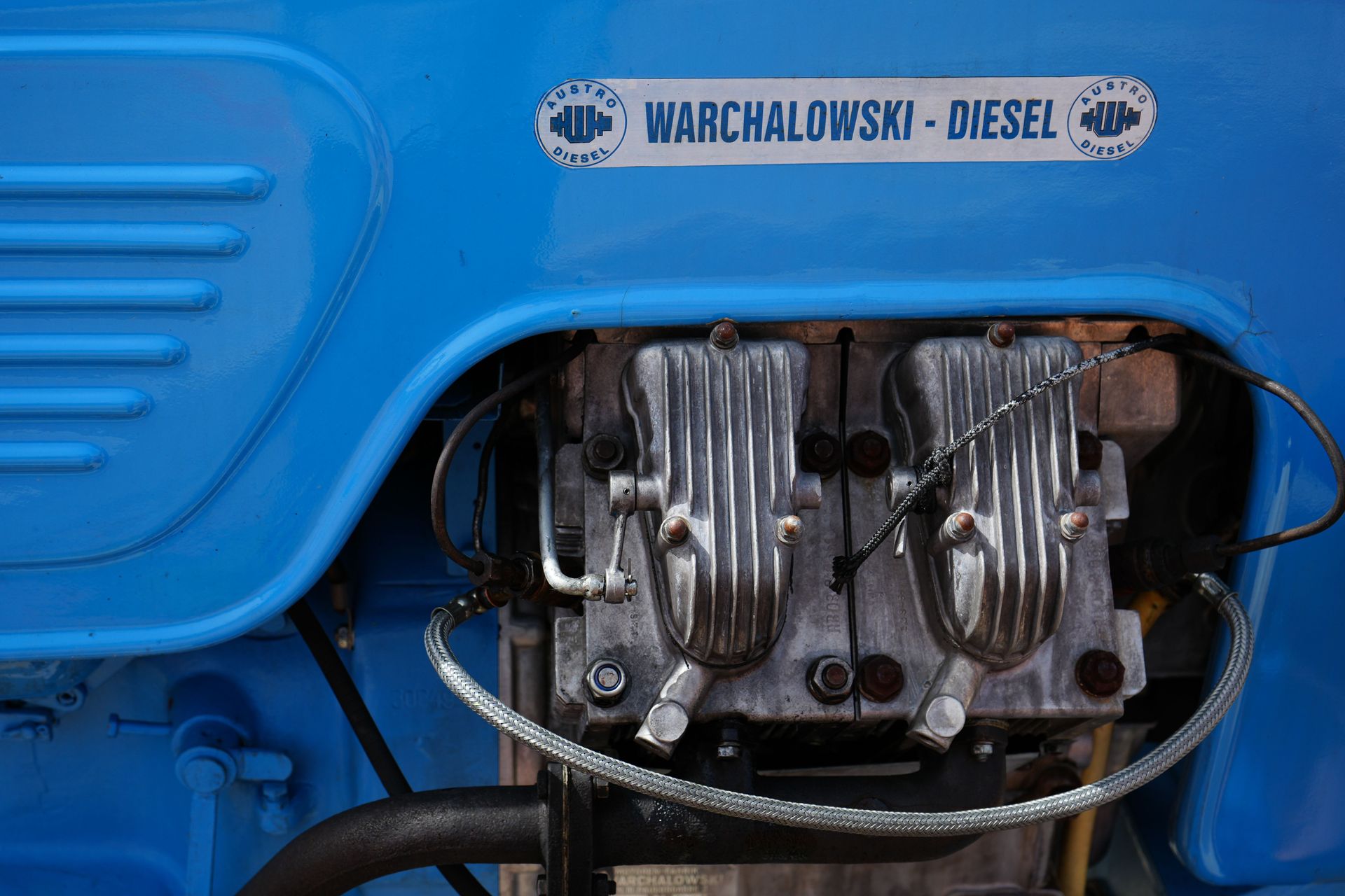 Close-up of a blue diesel engine with metal components and a Warchalowski-Diesel label