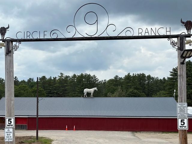 camp entrance - Circle 9 Ranch sign overlooking rooftop