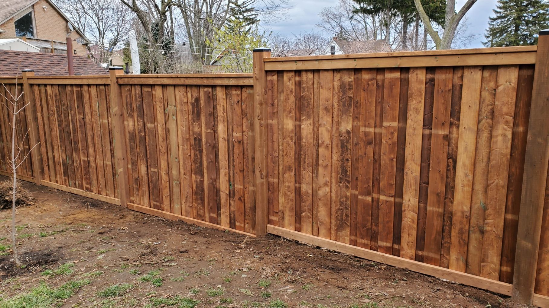 a wooden fence is sitting in the middle of a yard .