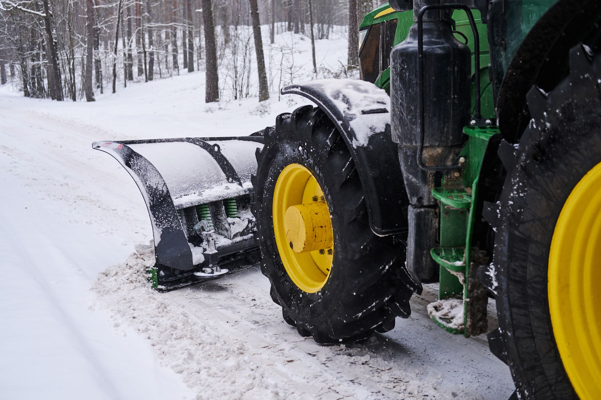two men standing in the snow holding shovels