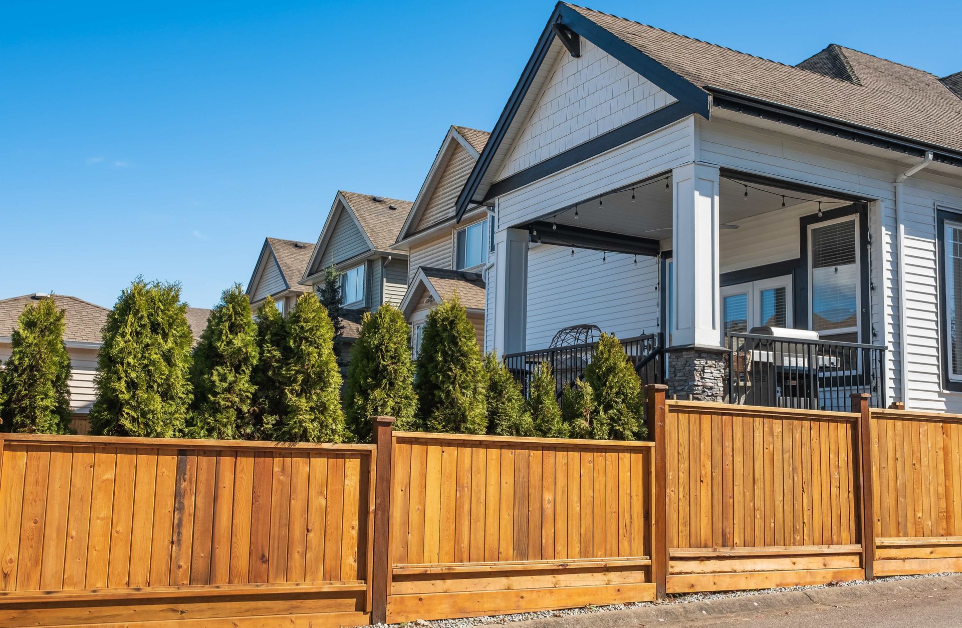 a house with a wooden fence in front of it