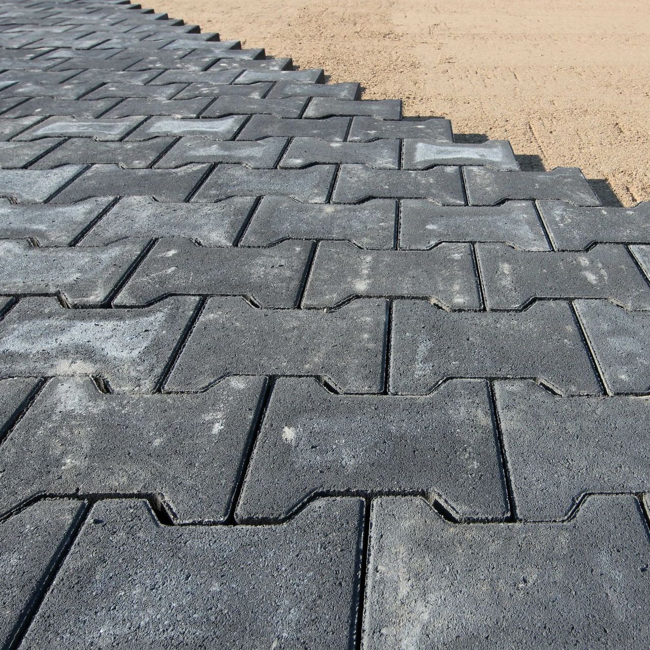 a row of gray bricks are laying on the ground