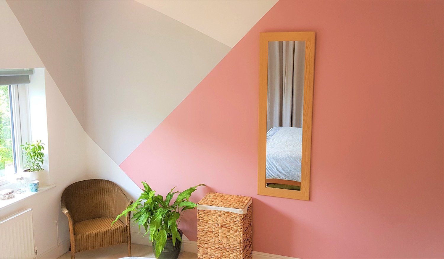 Beautiful Wall Paint — Gig Harbor, WA — Harbor Quality Painting, LLC Modern bedroom corner with soft pink painted feature wall and natural wood accents.