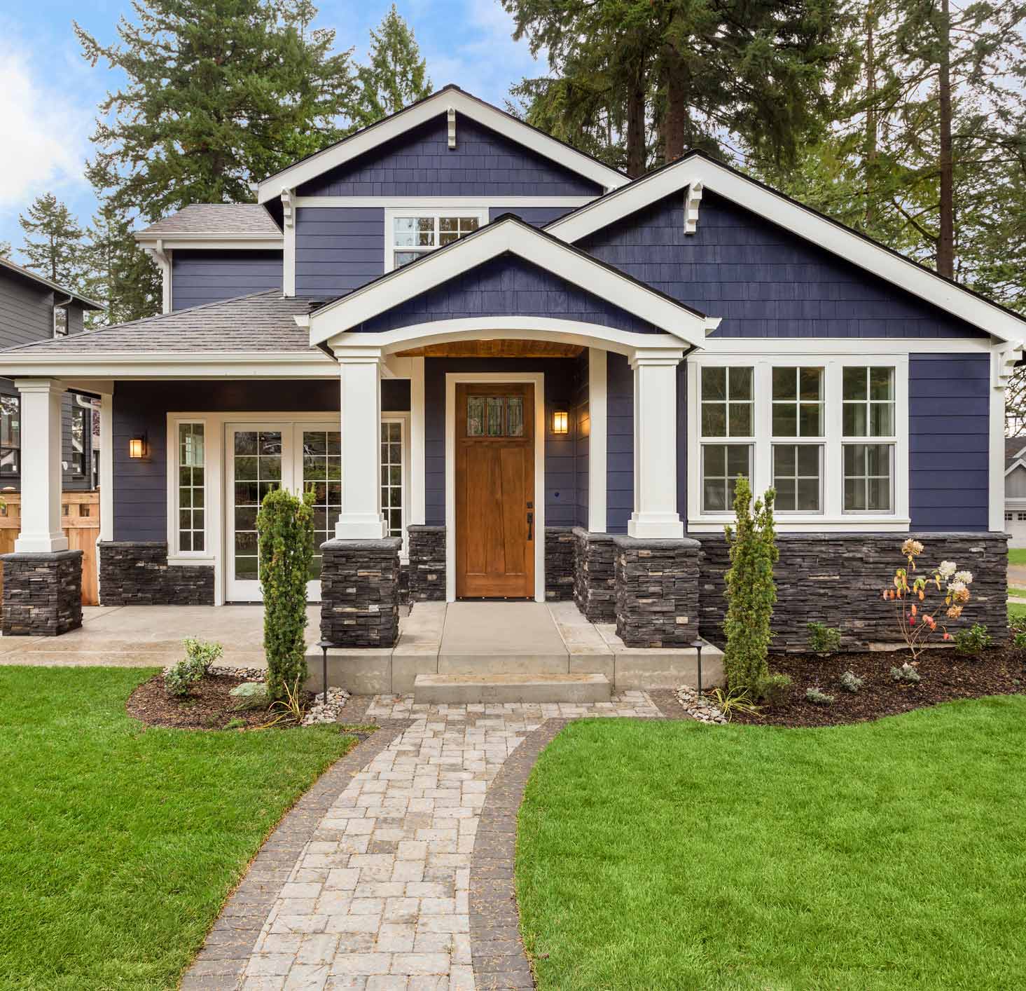 Modern House Exterior — Gig Harbor, WA — Harbor Quality Painting, LLC Modern navy blue craftsman home with freshly painted exterior, white trim, and stone accents.