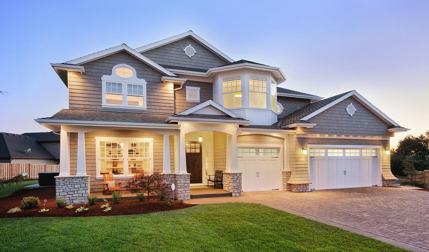 House at Night — Gig Harbor, WA — Harbor Quality Painting, LLC Two-story home at sunset with freshly painted exterior and trim in warm neutral colors.