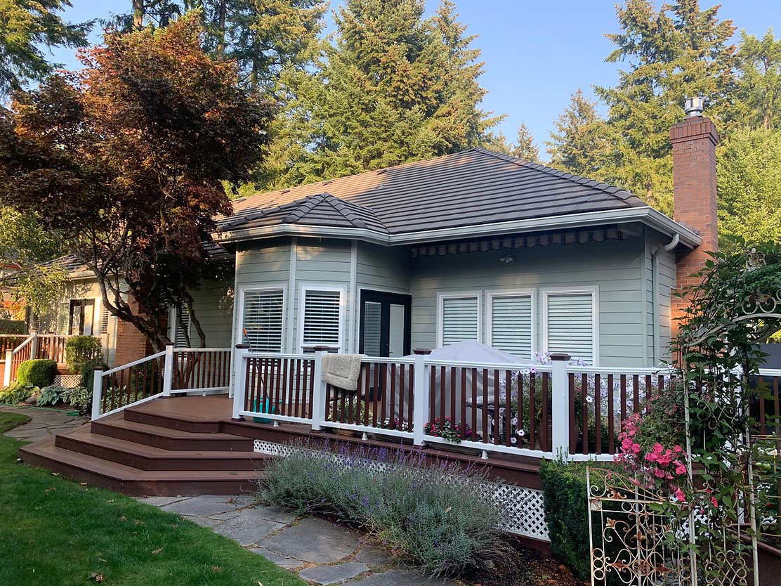 Small cottage-style home with newly painted light green siding and white trim.
