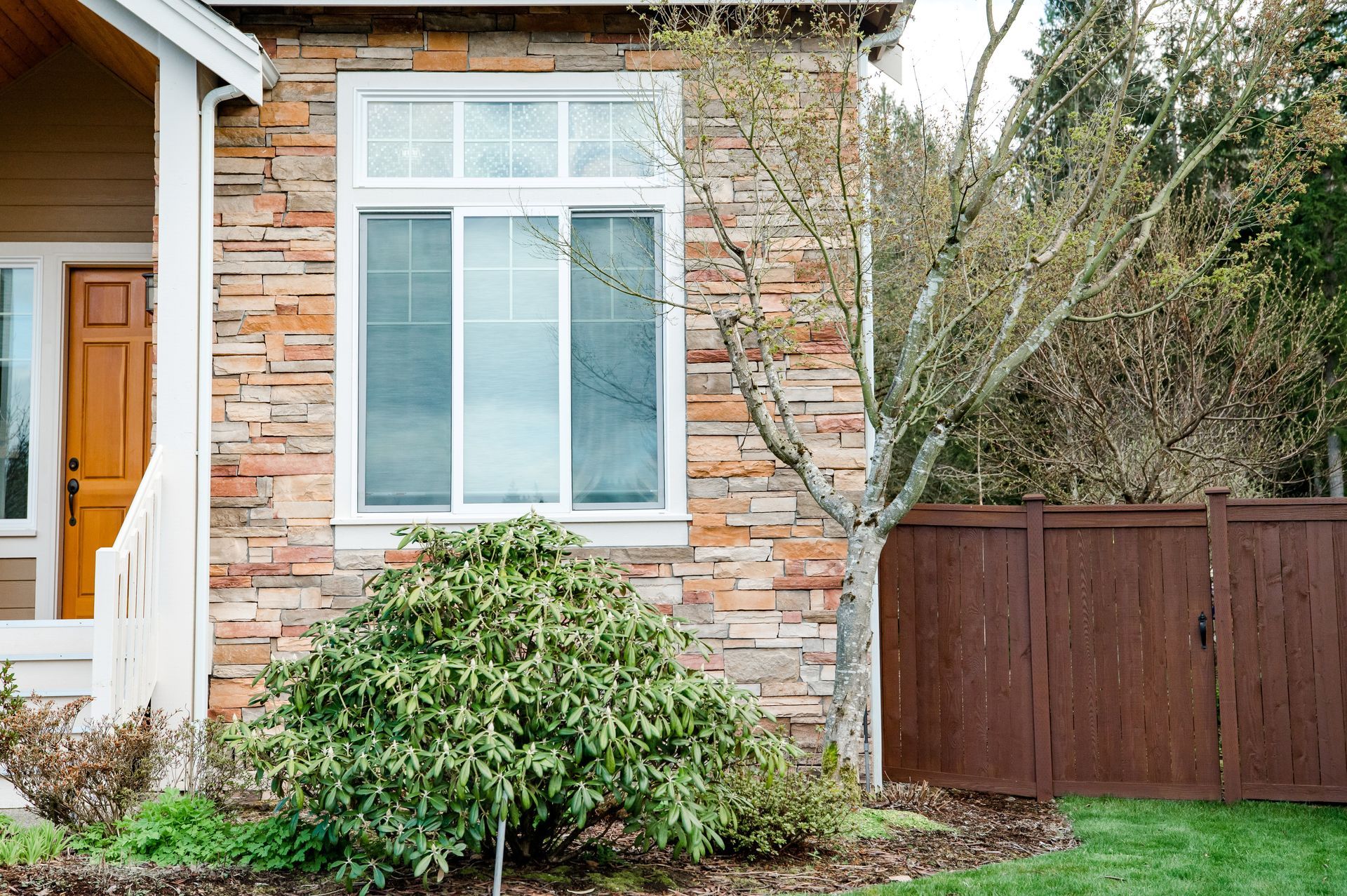 A brick house with a wooden fence in front of it
