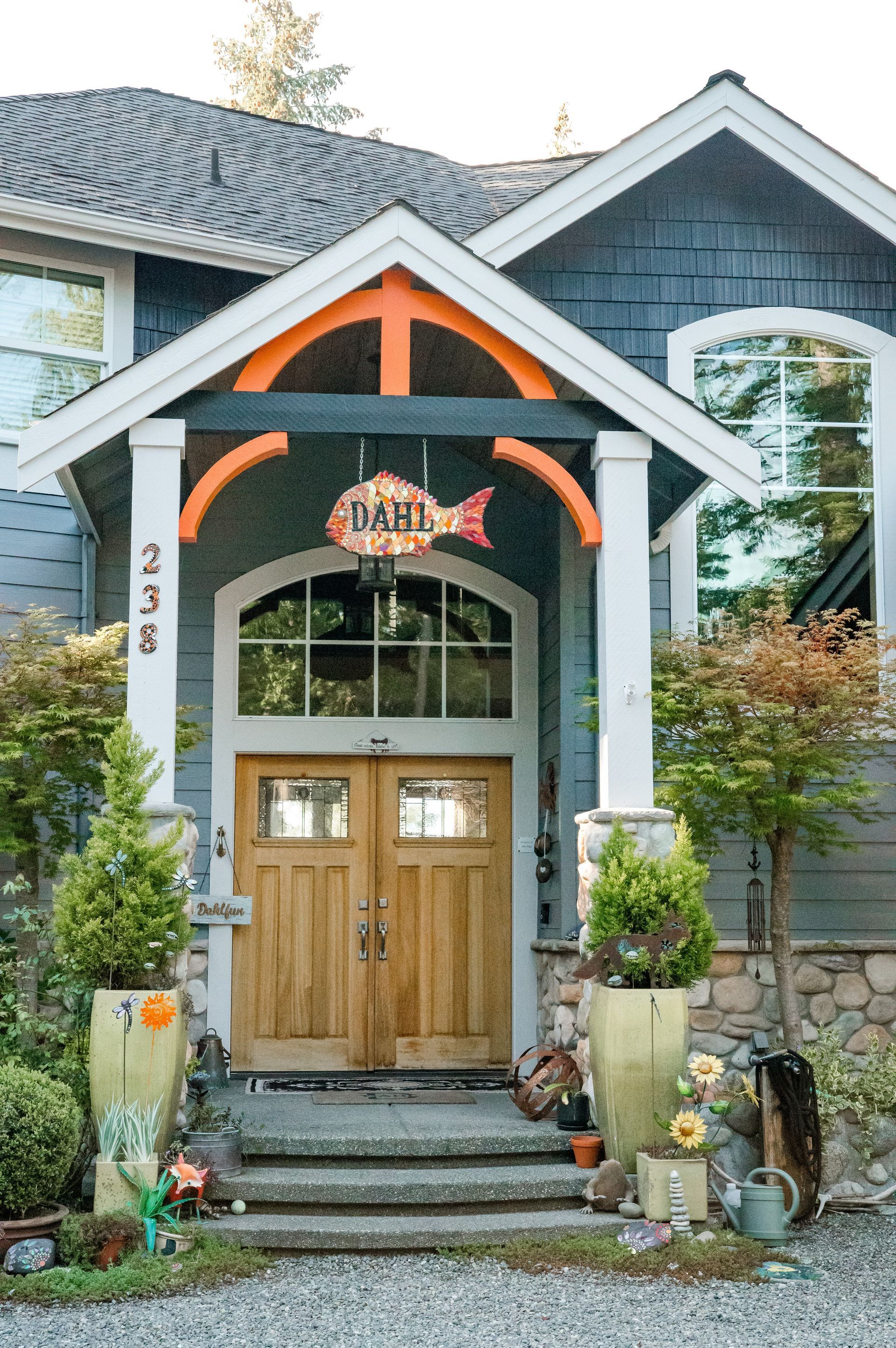 The front door of a house with a fish sign above it