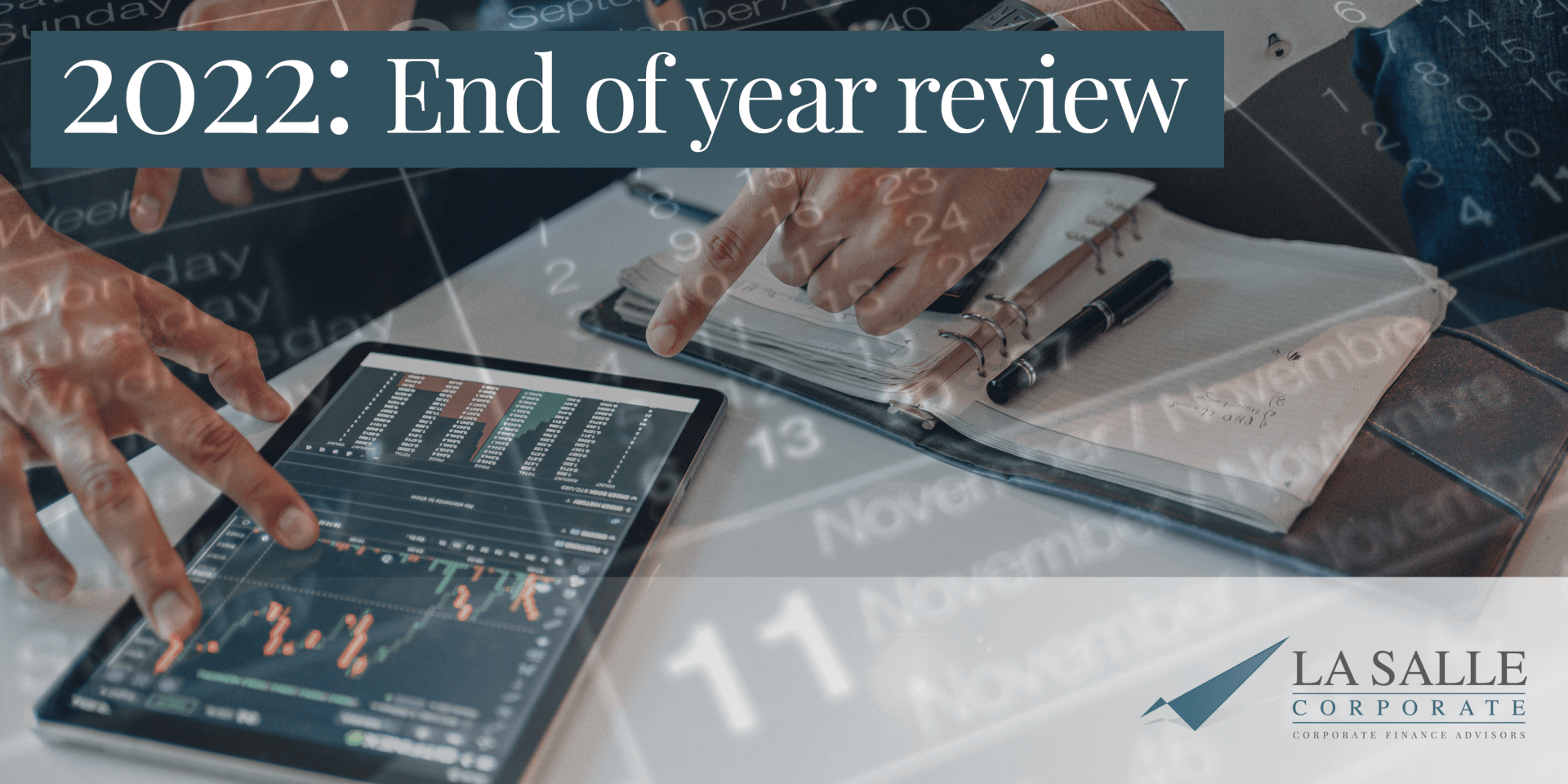 2022 end-of-year review with people analyzing charts on a tablet and laptop at a desk