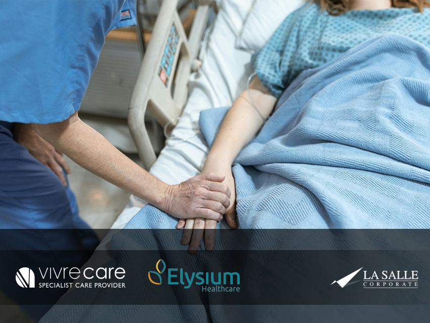 Nurse holding a patient’s hand beside a hospital bed, with VIVICARE, Elysium, and La Salle logos below