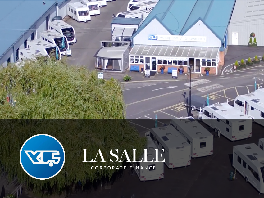 La Salle building exterior with parked vehicles and blue logo banner