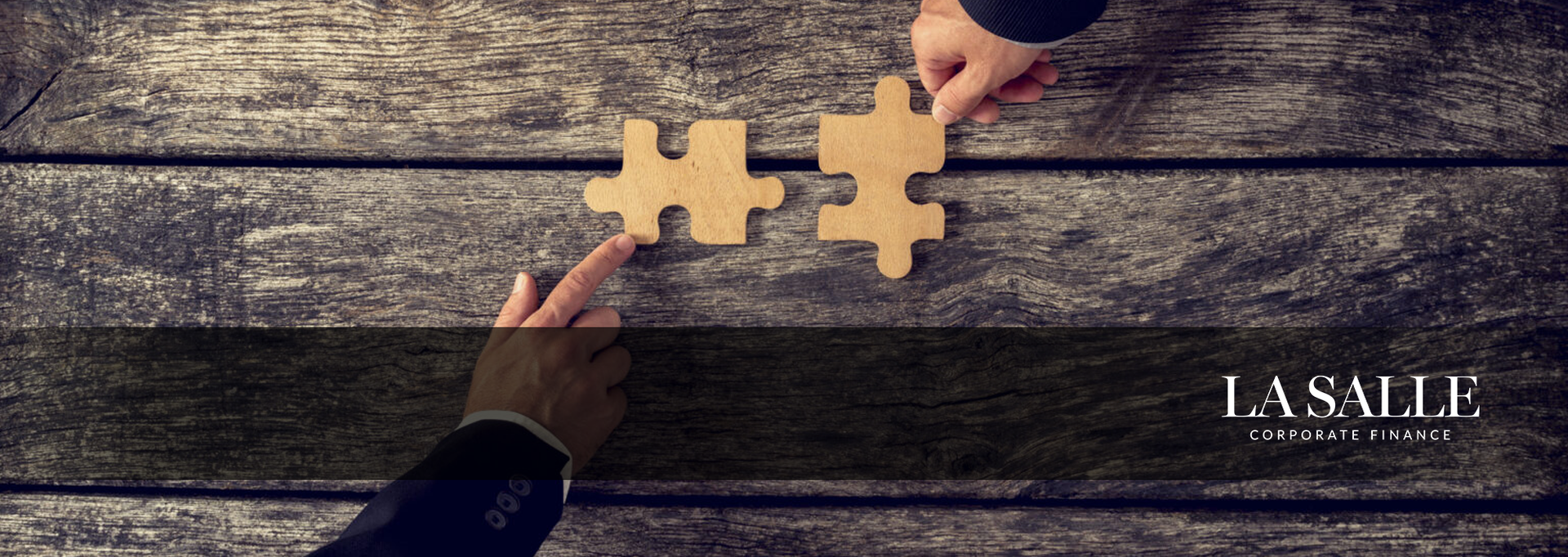 Hands assembling tan puzzle pieces on a wooden table with “I CARE” text on the right