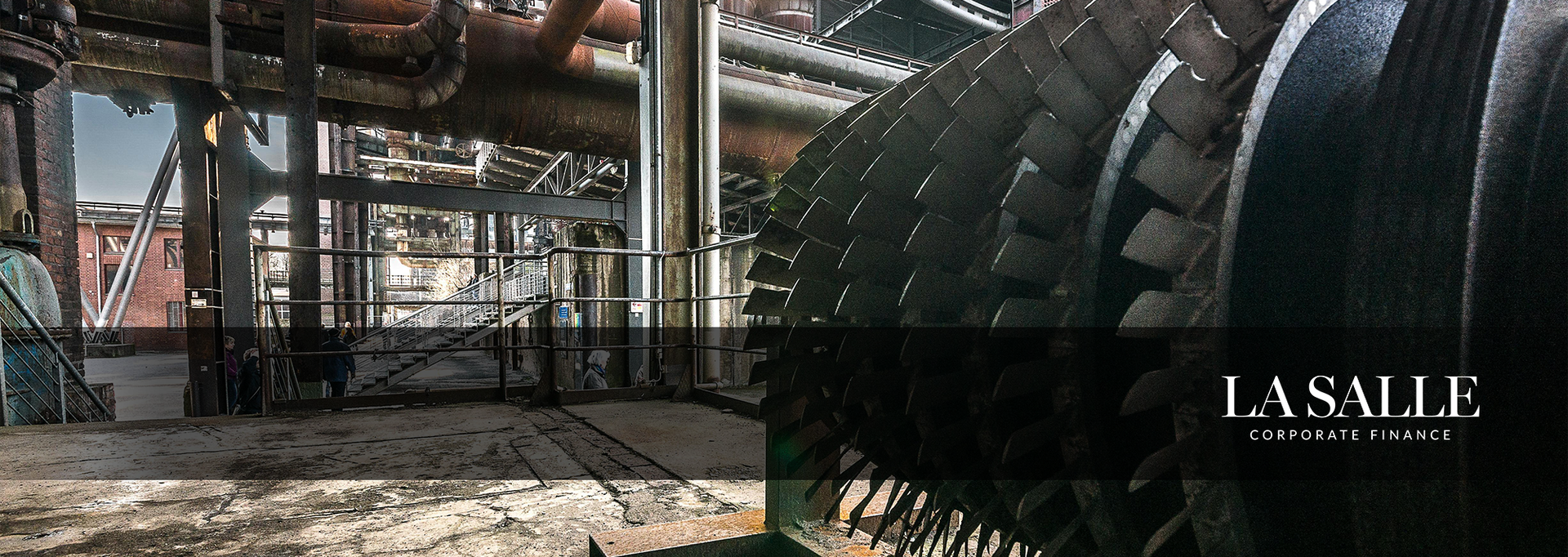Industrial steel structure interior with rows of large cylindrical tanks and pipes in a factory-like setting